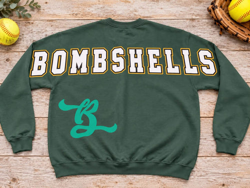 Forest green Bombshells softball crewneck sweatshirt back print with large white letters outlined gold and teal B emblem