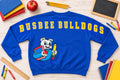 Royal blue Busbee Bulldogs sweatshirt with oversized yellow back lettering and bulldog mascot holding school supplies