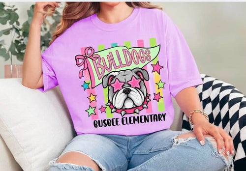 Purple Busbee Elementary Bulldogs tee with a bulldog in pink star glasses, a bow, colorful stripes, and stars