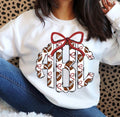 White crewneck sweatshirt with a scalloped football-pattern monogram, stitched-look black outlines, small garnet bows, and a large garnet bow above the initials