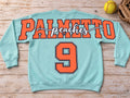 Aqua Palmetto Peaches softball crewneck sweatshirt with orange varsity lettering and large number nine on full back