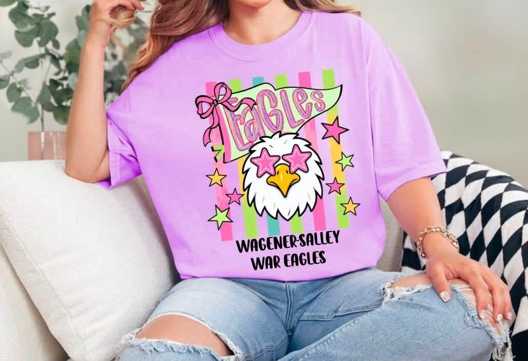 Purple Wagener-Salley War Eagles tee with an eagle in pink star glasses, a bow, colorful stripes, and stars